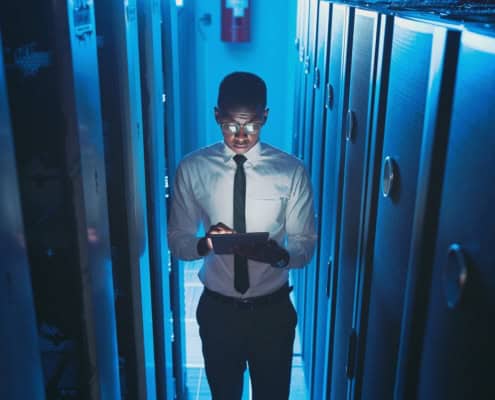 Tecnico IT con tablet nella sala server: controllo degli accessi ai sistemi aziendali.